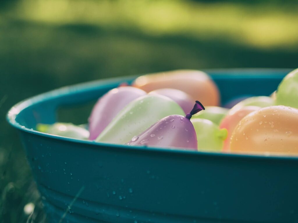 Water ballon fight one og the best camping games for adults